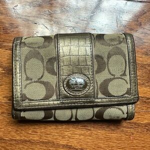 Coach wallet classic signature canvas pattern paired with metallic leather trim